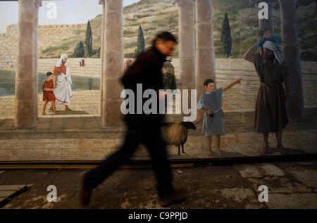 A visitor pass painted wall depicting life in biblical times in the ancient underground Hezekiah's Tunnel East Jerusalem Israel Stock Photo