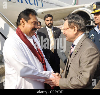 Sri Lanka President, Mahinda Rajapaksa being received by Senate Chairman, Farooq H.Naek upon his arrival at Chaklala Airbase in Islamabad on Friday, February 10, 2012. Stock Photo