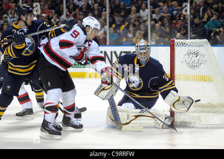 Feb. 14, 2012 - Buffalo, New York, U.S - New Jersey Devils left wing Zach Parise (9) just misses the redirection shot on Buffalo Sabres goalie Ryan Miller (30) while taking the hit from Buffalo Sabres right wing Brad Boyes (22) during the third period at the First Niagara Center in Buffalo, New York Stock Photo