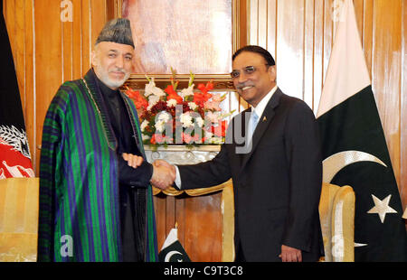 President, Asif Ali Zardari shakes hand with his Afghan counterpart, Hamid Karzai before meeting at Aiwan-e-Sadr in Islamabad on Thursday, February 16, 2012. Stock Photo