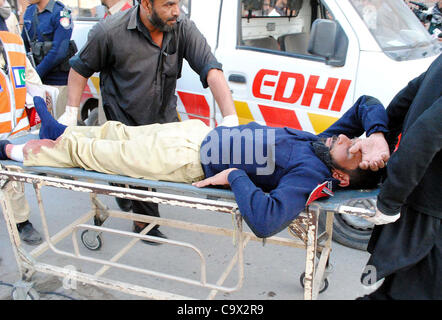 An injured policeman, who was injured in explosion in Nowshera, being shifted at Lady Reading hospital (LRH) in Peshawar on Monday, February 27, 2012. Atleast five people were killed and fifteen people were injured in remote-controlled bomb  explosion after Awami National Stock Photo