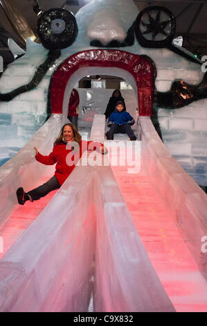 A woman slides down the ice on the famous ‘Monster’ slide carved of ice at Jerusalem’s first International Ice Festival set to open March 6th. Jerusalem, Israel. 28-Feb-2012. Stock Photo