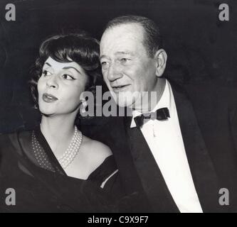 JOHN WAYNE with wife Pilar in a family portrait spanning three ...