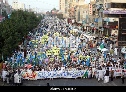 Leader and supporters of Jamat-e-Islami (JI) pass through University road during protest rally against desecration of the Holy Quran by US soldiers in Afghanistan, in Karachi on Friday, March 02, 2012. Stock Photo