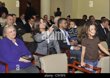 Nassau County Legislature, controlled by Republicans, votes along party lines to consolidate 8 police precincts into 4, on Monday, March 5, 2012, at Mineola, New York, USA. Milagros Vicente (center, pointing finger), a North Valley Stream resident, was one of those shouting protest after a Yes vote. Stock Photo