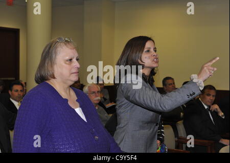 Nassau County Legislature, controlled by Republicans, votes along party lines to consolidate 8 police precincts into 4, on Monday, March 5, 2012, at Mineola, New York, USA. Milagros Vicente (right, pointing finger), a North Valley Stream resident, was one of those shouting protest after a Yes vote. Stock Photo
