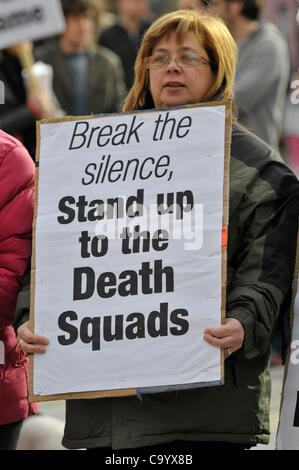 10 March 2012 - Londonderry, Northern Ireland, UK - A protester holding a placard at a rally calling for a republican  vigilante group, Republican Action Against Drugs (RAAD) to disband following punishment shootings in the Bogside on  Wednesday last, death threats and the killing of a father of two Stock Photo