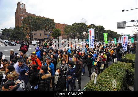 Tokyo, Japan - March 11: Hundreds of thousands of people walked and shout against nuclear power plants during a demonstration at Chiyoda, Tokyo, Japan on March 11, 2012. As this day was one year anniversary of Great East Japan Earthquake and Tsunami, there were many demonstrations held in the city. Stock Photo