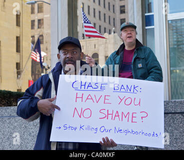 Detroit, USA. 13 Mar, 2012. A protester holds a sign at a rally against the foreclosure polices of Chase Bank in Detroit, Michigan. About 200 people marched from the statue of the Spirit of Detroit to the bank. Stock Photo