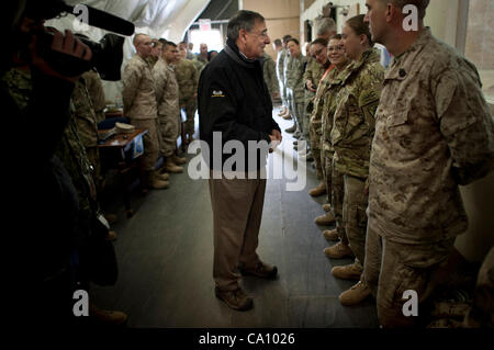 US Defense Secretary Leon Panetta greets service members transiting into or out of Afghanistan at the Manas Air Base Transit Center March 14, 2012 in Kyrgyzstan. Panetta is on a four day trip to the region to meet with counterparts and visit troops. Stock Photo