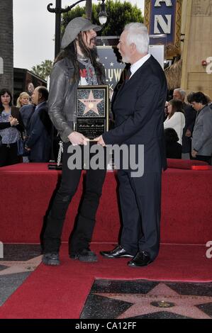 Rob Zombie, Malcolm McDowell at the induction ceremony for Star on the Hollywood Walk of Fame for Malcolm McDowell, Hollywood Boulevard, Los Angeles, CA March 16, 2012. Photo By: Michael Germana/Everett Collection Stock Photo