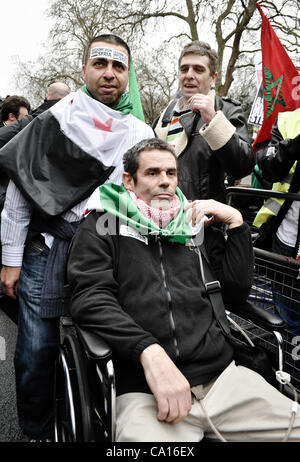 17/03/2012, London, UK: Paul Conroy, a Sunday Times photographer who was injured in Syria, makes an appearance at an Anti-Assad rally outside the Syrian Embassy in London and addresses the crowd. He spent most of the day in a wheelchair. Stock Photo