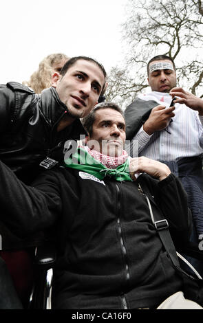 17/03/2012, London, UK: Paul Conroy, a Sunday Times photographer who was injured in Syria, makes an appearance at an Anti-Assad rally outside the Syrian Embassy in London and addresses the crowd. He spent most of the day in a wheelchair. Stock Photo