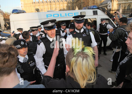LONDON, UK, 20th Mar, 2012. Police hold back other protesters who are agitated after another activists is arrested. Activists gathered in Parliament Square to protest against the proposed anti squatting law being voted on in the house of lords. Stock Photo
