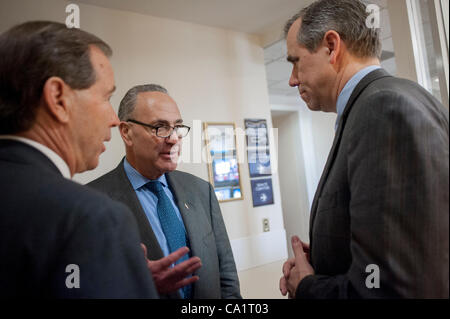 March 21, 2012 - Washington, District of Columbia, U.S. - Senator TOM UDALL (D-MN), Senate Rules and Administration Chairman CHUCK SCHUMER (D-NY) and Senator JEFF MERKLEY (D-OR) confer before a press conference to announce new legislation ''to blunt the worst effects'' of the Supreme Court's Citizen Stock Photo