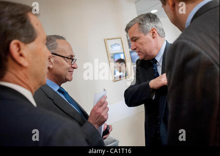 March 21, 2012 - Washington, District of Columbia, U.S. - Senator TOM UDALL (D-MN), Senate Rules and Administration Chairman CHUCK SCHUMER (D-NY) and Senator SHELDON WHITEHOUSE (D-RI) confer before a press conference to announce new legislation ''to blunt the worst effects'' of the Supreme Court's C Stock Photo
