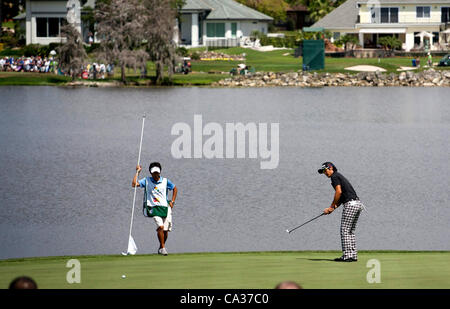 (L-R) Hiroyuki Kato, Ryo Ishikawa (JPN), MARCH 23, 2012 - Golf : Ryo Ishikawa of Japan puuts on the green of 6th hole as his caddie looks on during the second round of the Arnold Palmer Invitational at Arnold Palmer's Bay Hill Club and Lodge in Orlando, Florida. (Photo by Thomas Anderson/AFLO)(JAPAN Stock Photo