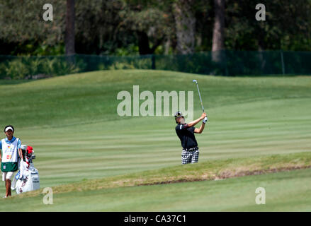 (L-R) Hiroyuki Kato, Ryo Ishikawa (JPN), MARCH 23, 2012 - Golf : Ryo Ishikawa of Japan shoots a ball on the 5th hole as his caddie looks on during the second round of the Arnold Palmer Invitational at Arnold Palmer's Bay Hill Club and Lodge in Orlando, Florida. (Photo by Thomas Anderson/AFLO)(JAPANE Stock Photo