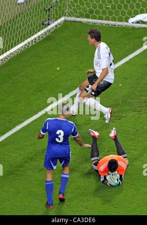 31.05.2012. Leipzig, Germany.  Germany's Mario Gomez (top) and Israel's goalkeeper Ariel Harush (r) and Tal Ben Haim challenge for the ball during the international friendly soccer match Germany vs Israel at Red Bull Arena in Leipzig, Germany, 31 May 2012. Stock Photo