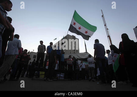 May 31, 2012 - Cairo, Cairo, Egypt - Protesters wave the revolutionary flag and shout slogans as they protest against the weekend massacre of Houla, in front of the Syrian embassy in Cairo, Egypt, 31 May 2012. A massacre was reported in the central Syrian city of Houla over the weekend, however the  Stock Photo