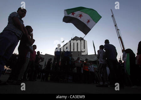 May 31, 2012 - Cairo, Cairo, Egypt - Protesters wave the revolutionary flag and shout slogans as they protest against the weekend massacre of Houla, in front of the Syrian embassy in Cairo, Egypt, 31 May 2012. A massacre was reported in the central Syrian city of Houla over the weekend, however the  Stock Photo