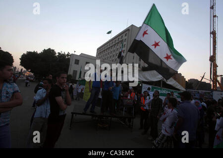 May 31, 2012 - Cairo, Cairo, Egypt - Protesters wave the revolutionary flag and shout slogans as they protest against the weekend massacre of Houla, in front of the Syrian embassy in Cairo, Egypt, 31 May 2012. A massacre was reported in the central Syrian city of Houla over the weekend, however the  Stock Photo