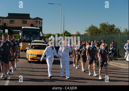 Birkenhead, UK, 1st June, 2012. The Olympic Torch relay arrives in Birkenhead through the Wallasey Tunnel on a route back Liverpool on the Mersey Ferry via Birkenhead Park. Brian Powell, Registered Blind, walks with his daughter. Stock Photo