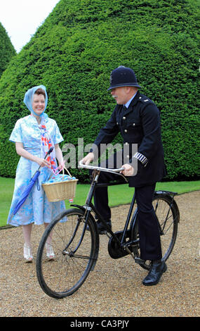02 June 2012. Hampton Court, England, UK. The Jubilee Garden Party at Hampton Court Palace with 1950's 'Policeman' and lady in 50's dress. Stock Photo