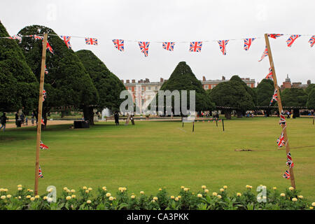 02 June 2012. Hampton Court, England, UK. Flags flying against cloudy sky at the start of the Diamond Jubilee weekend. Stock Photo