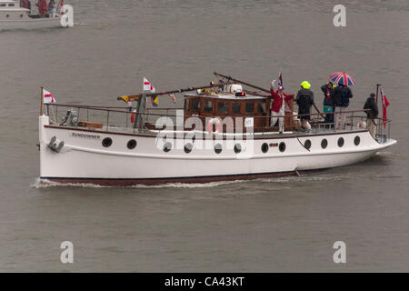 The Sundowner, a Dunkirk Little Ship proceeds along River Thames, as part of the Queen’s Thames Diamond Jubilee Pageant, taken from Tower Bridge, London, UK, 3rd June 2012. The Diamond Jubilee celebrates Queen Elizabeth the second’s 60 years as Head of the Commonwealth. Stock Photo