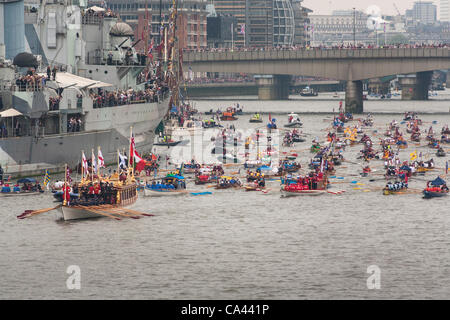 Numerous small boats proceed along River Thames past HMS Belfast as part of the Queen’s Thames Diamond Jubilee Pageant, taken from Tower Bridge, London, UK, 3rd June 2012. The Diamond Jubilee celebrates Queen Elizabeth the second’s 60 years as Head of the Commonwealth. Stock Photo