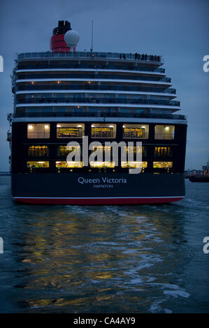 Southampton, UK. The three Cunard cruise ships Queen Elizabeth, Queen Victoria and Queen Mary 2 arrive at Southampton Docks at dawn for the diamond jubilee celebrations on June the 5th 2012. Image shows aft end of Queen Victoria entering Southampton harbour Credit:  Stefan Venter / Alamy Live News Stock Photo