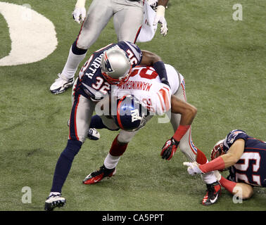 Feb. 5, 2012 - Indianapolis, IN, USA - New York Giants wide receiver Mario Manningham #82 gets tackled by New England Patriots cornerback Devin McCourty #32 and New England Patriots free safety Sterling Moore #29 during Super Bowl XLVI. Super Bowl XLVI came down to the final seconds as the New York  Stock Photo