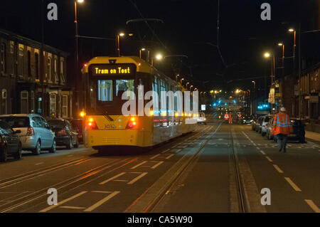 Wed 13th June 2012.  In the early hours of the morning a Manchester Metrolink tram makes the very first test run to Droylsden, Tameside, UK, on the street running section of the East Manchester Line.  The line is due to open to passenger traffic later this year. Stock Photo