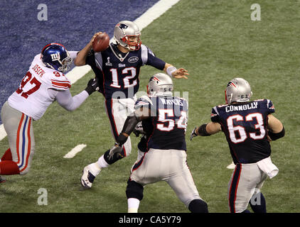 Feb. 5, 2012 - Indianapolis, IN, USA - New England Patriots quarterback Tom Brady #12 gets pressured by New York Giants defensive tackle Linval Joseph #97 during Super Bowl XLVI. Super Bowl XLVI came down to the final seconds as the New York Giants beat the New England Patriots with a final score of Stock Photo