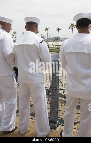 Sailors look across to the SS Lane Victory from the final voyage of the battleship USS Iowa from Berth 51 to its new home at Berth 87 in San Pedro, Los Angeles, CA where it opens as a museum ship in July 2012. Stock Photo