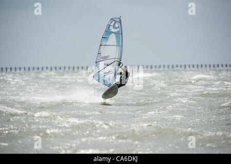 16th June 2012, Shoeburyness, Essex, UK. The winds have returned but this time with sun. This brought out a number of windsurfers to make the most of the bright and windy conditions. Stock Photo