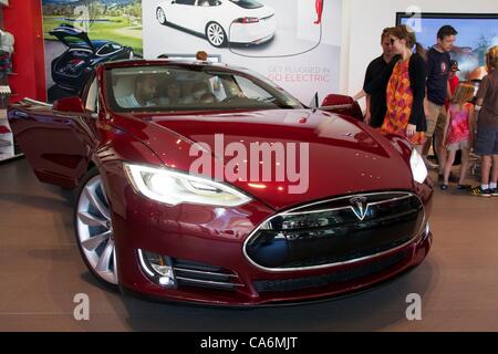 17, June, 2012, Oak Brook, Illinois, USA. Prospective customers consider the new Tesla Motors Model S. The Model S, an all electric car, with up to a 300 mile range and under 6 second 0-60 mph acceleration, goes on sale this month. Stock Photo