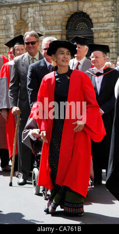 Oxford, UK. Wednesday June 20th 2012. Daw Aung San Suu Kyi (in red) walks in the Oxford University Encaenia procession. Aung San Suu Kyi is Chairman of the Burmese National League for Democracy and member of the Burmese parliament  She is awarded the Honorary Degree of Doctor of Civil Law by Oxford University from which she graduated in 1969 in recognition of her fight for democracy in Burma. Stock Photo