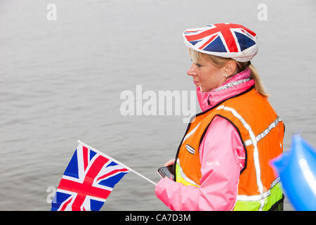 Thursday 21st June 2012. A steward stands in Lake Windermere, as the Olympic torch passes through Ambleside and travels to Bowness on a boat, Lake District, UK. Stock Photo