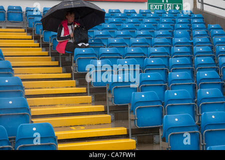 22/06/2012 Headingley England.  A lone woman sits under an umbrella during a rain delayed  Nat West Series international cricket 3rd one day match between England and the West Indies at the Headingley Carnigie Ground. Stock Photo