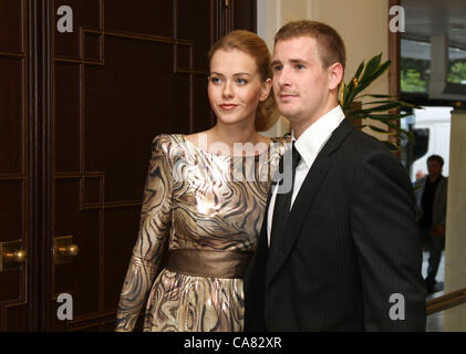 The annual award Golden Hockey Stick for the best ice hockey player of the season was announced in Karlovy Vary, Czech Republic on June 23, 2012. Czech ice hockey player Roman cervenka (right) enters the gala evening with his girlfriend Veronika Machova. (CTK Photo/Jan Sokol) Stock Photo