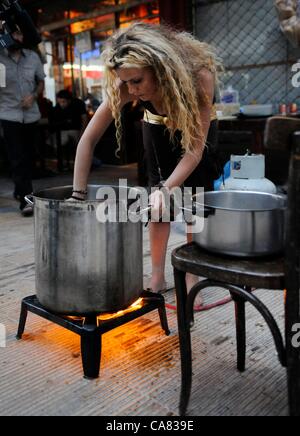 Monday June 25th 2012, Athens, Greece. Volunteers of the group 'O Allos Anthropos' (the other people) serve free food and clothes for all at Metaxurgio pedestrian area, in Athens. After 5 years of greek recession, growing numbers rely on charity and generosity. Stock Photo