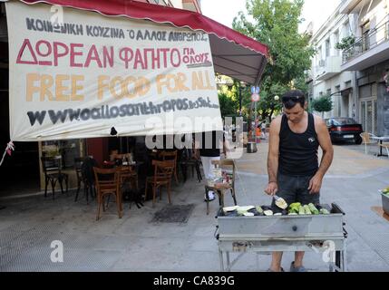 Monday June 25th 2012, Athens, Greece. Volunteers of the group 'O Allos Anthropos' (the other people) serve free food and clothes for all at Metaxurgio pedestrian area, in Athens. After 5 years of greek recession, growing numbers rely on charity and generosity. Stock Photo