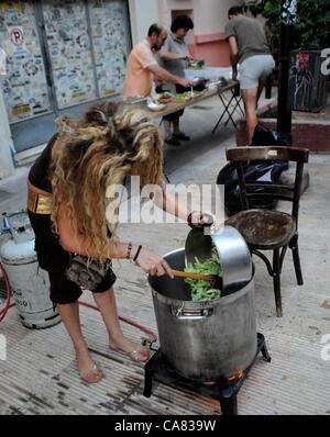 Monday June 25th 2012, Athens, Greece. Volunteers of the group 'O Allos Anthropos' (the other people) serve free food and clothes for all at Metaxurgio pedestrian area, in Athens. After 5 years of greek recession, growing numbers rely on charity and generosity. Stock Photo