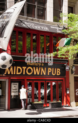 New York City, USA. 26th June 2012.   The UEFA EURO 2012 broadcasts have extended pub hours to accommodate the world time zone differences.  Slattery's giant soccer ball display indicates that the tournament is featured on their electronic screens. Stock Photo
