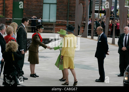 Her Majesty the Queen accompanied by Dame Mary Peters, is greeted by a Cadet at the Belfast Titanic building which Her Majesty officially opened Stock Photo