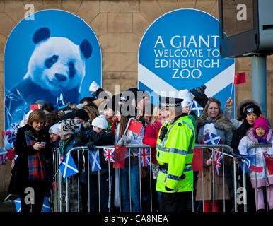 04 December 2011 Nicola Sturgeon, Deputy First Minister of Scotland shows photos of Pandas to children who anticipate the arrival of Giant Pandas at Edinburgh Zoo, Scotland, UK. Tian Tian and Yang Guang complete their overnight journey from China to arrive their new home Edinburgh Stock Photo