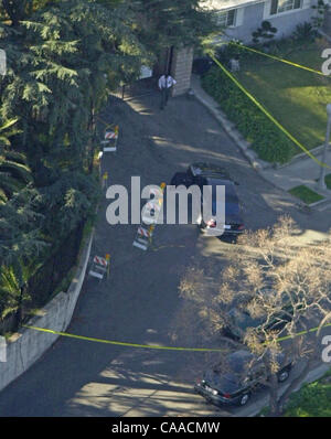 Feb 03, 2003; Alhambra, CA, USA; Investigators search a car outside the home of music producer Phil Spector, who was arrested on a first degree murder charge. Spector, 62, who produced groups from the Ronettes to The Beatles, has been charged with the shooting death of a woman at his home.  (Credit  Stock Photo