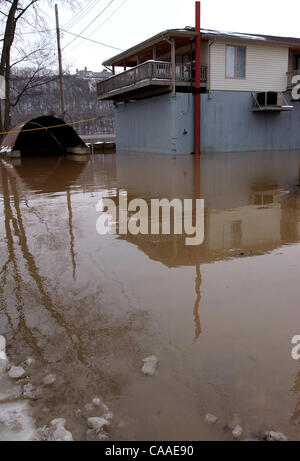 Feb 26, 2003 - Cincinnati, Ohio, USA - The rising waters of the Ohio River continue to swell to a flood stage of 52 feet, 26 feet over normal levels. Rising to a 6 year high, the water has covered the parking lots of restaurants, riverfront homes, flooded boat harbors, covered some low laying roads, Stock Photo